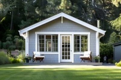Charming detached ADU with gray siding and a landscaped front yard.