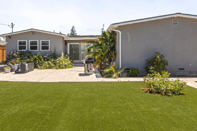 Backyard with artificial turf and modern landscaping in San Jose.